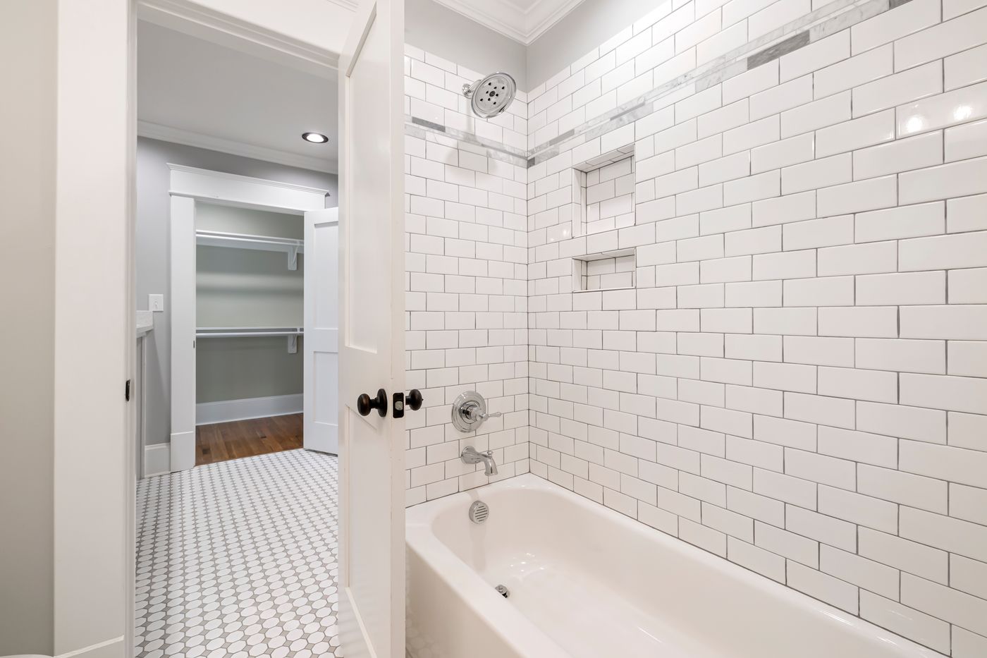 Remodeled bathroom with tiled bathtub and shower