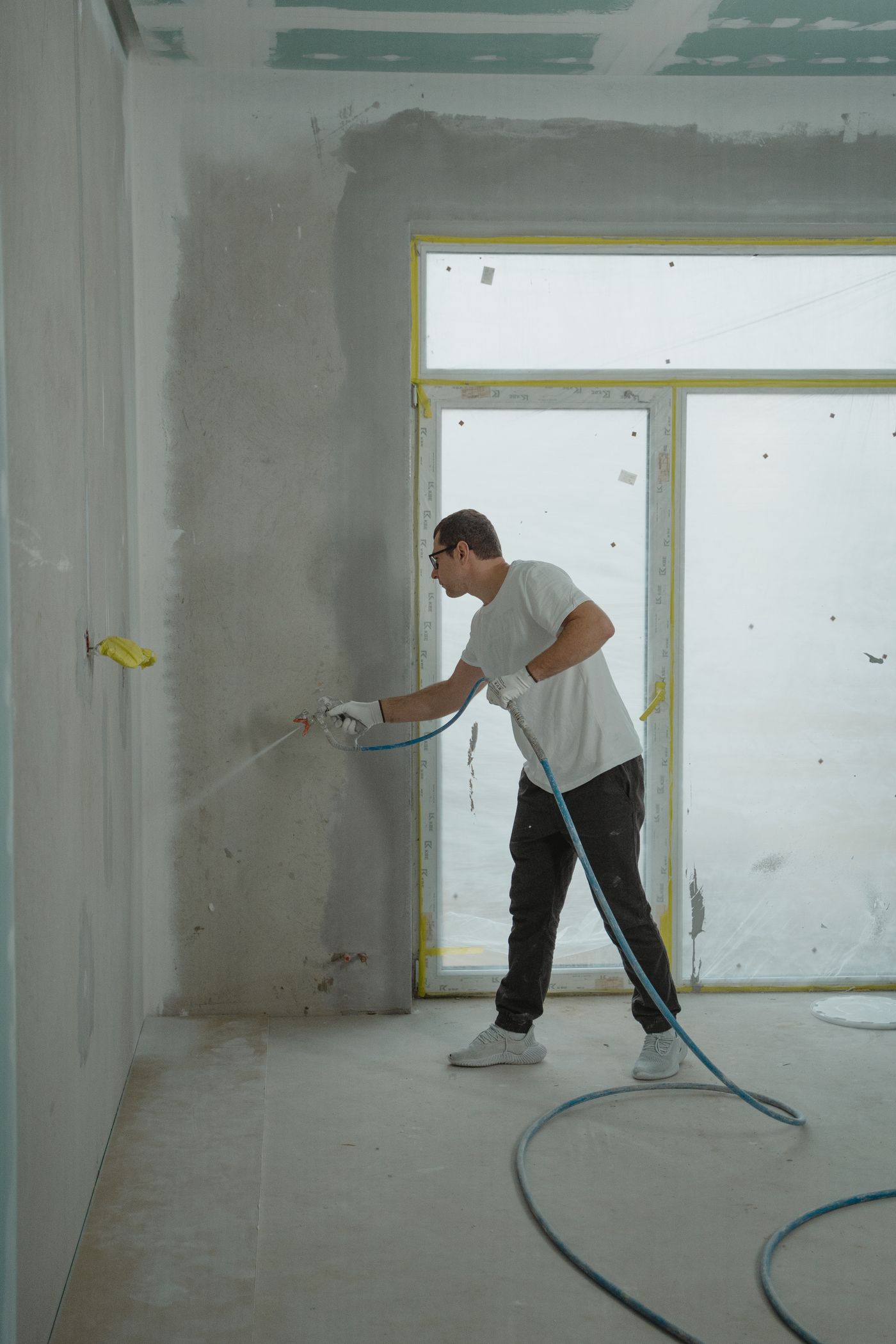 Painter applying paint to an interior wall